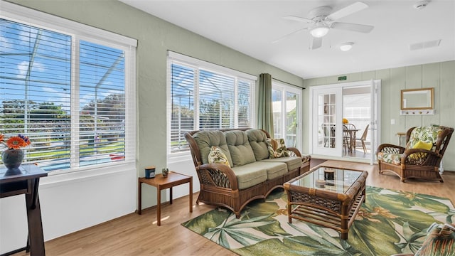 sunroom / solarium featuring ceiling fan and a healthy amount of sunlight