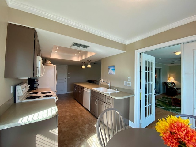 kitchen featuring white appliances, ornamental molding, a raised ceiling, and sink