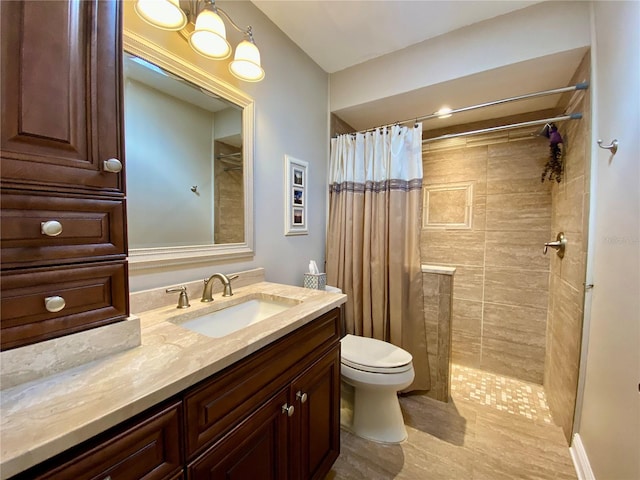 bathroom featuring walk in shower, vanity, and toilet