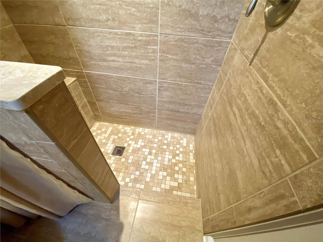 bathroom with tiled shower