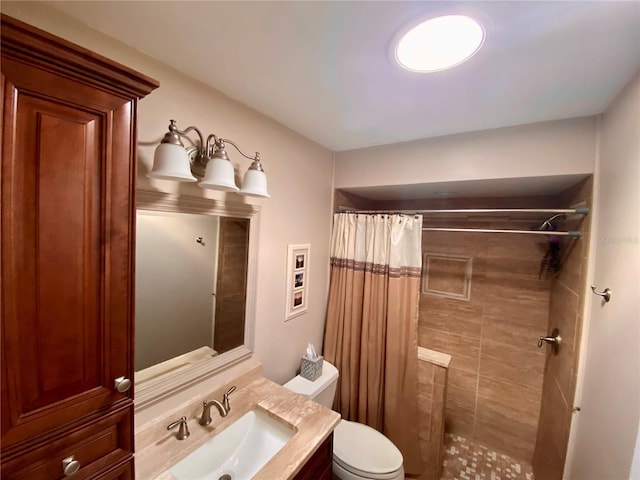 bathroom with walk in shower, vanity, and toilet