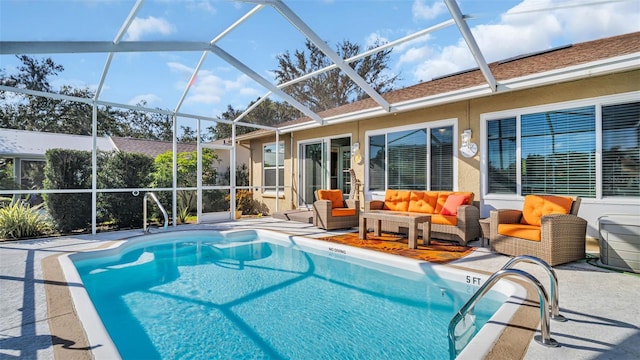 view of pool with outdoor lounge area, glass enclosure, and a patio area