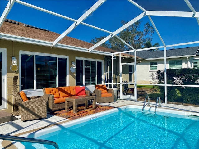 view of swimming pool with outdoor lounge area, glass enclosure, and a patio area