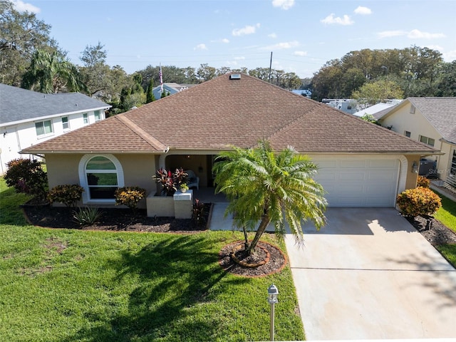 view of front of property featuring a front lawn and a garage