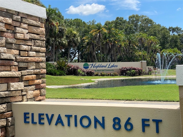 community sign featuring a lawn