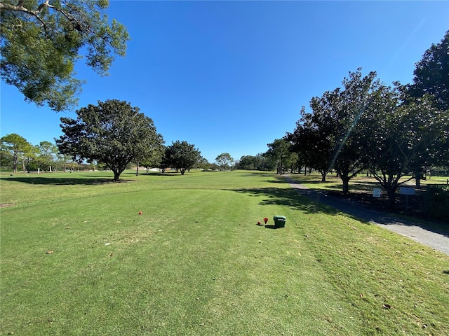 view of property's community with a lawn