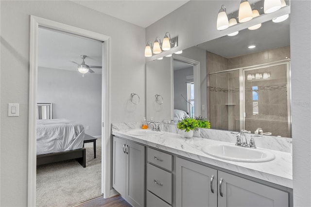 bathroom with an enclosed shower, vanity, and ceiling fan