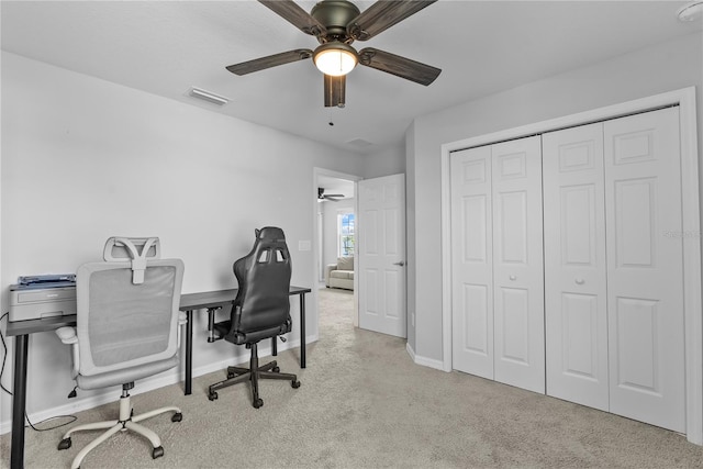 office space with light carpet and ceiling fan