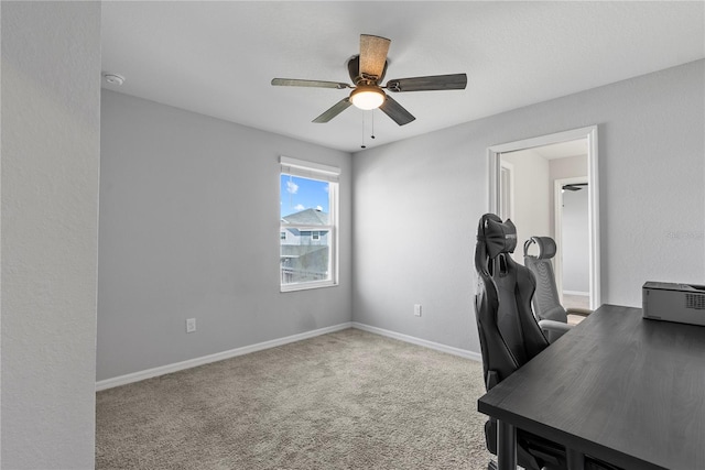 home office featuring ceiling fan and light carpet