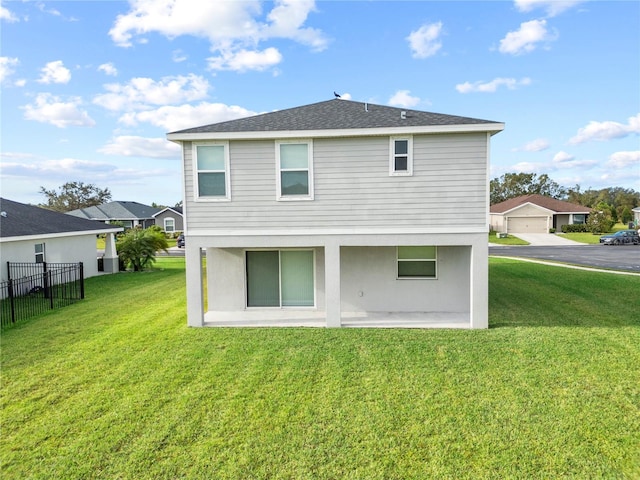 back of property featuring a patio and a lawn