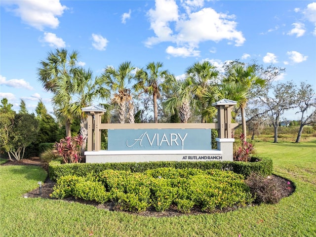 community / neighborhood sign with a lawn