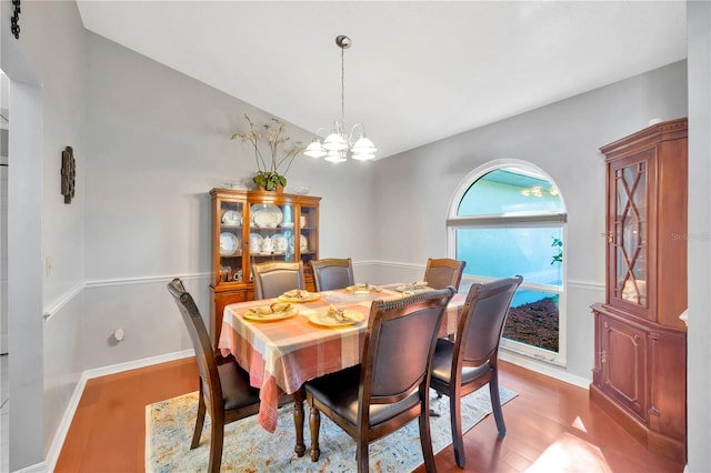 dining room featuring wood-type flooring and a chandelier