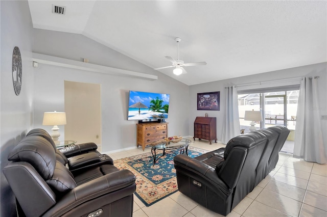 living room with ceiling fan, lofted ceiling, and light tile patterned flooring