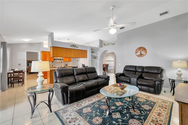 living room featuring light tile patterned floors, ceiling fan, and vaulted ceiling