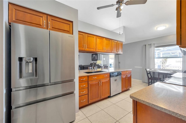 kitchen featuring stainless steel appliances, light tile patterned flooring, ceiling fan, and sink