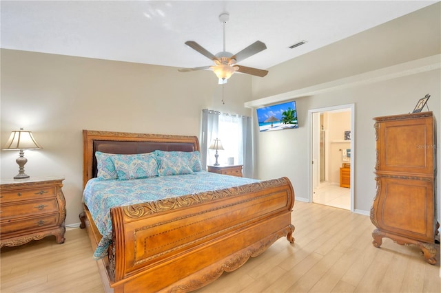 bedroom with ceiling fan, connected bathroom, and light wood-type flooring