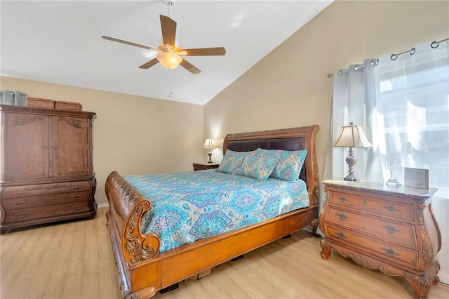 bedroom featuring ceiling fan, light wood-type flooring, and lofted ceiling