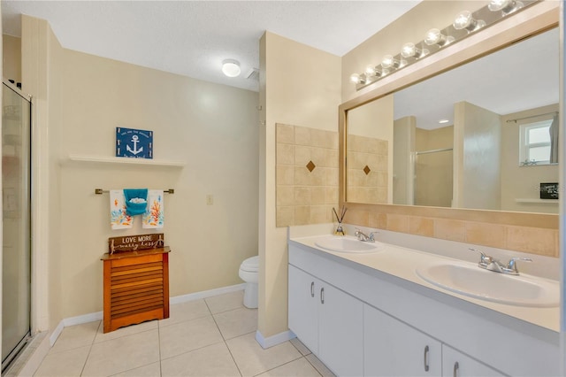 bathroom with a shower with door, a textured ceiling, vanity, tile patterned floors, and toilet