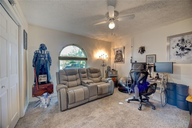 carpeted living room with a textured ceiling and ceiling fan