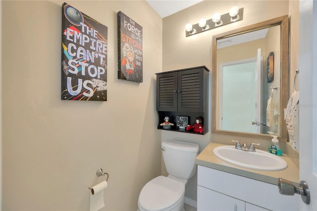 bathroom featuring toilet and vanity