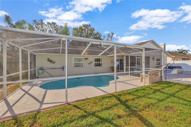 view of pool featuring a lanai, a lawn, and a patio