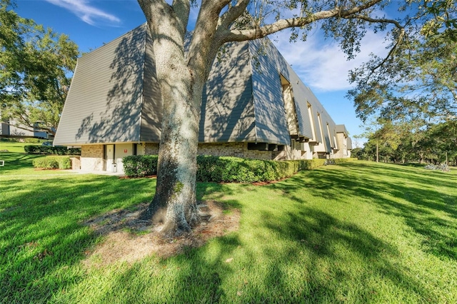 view of side of property with a lawn