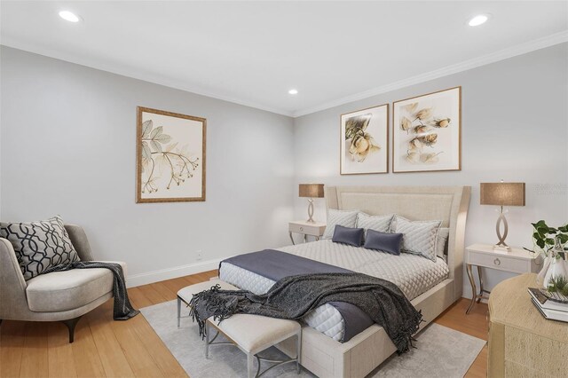 bedroom with light hardwood / wood-style flooring and ornamental molding