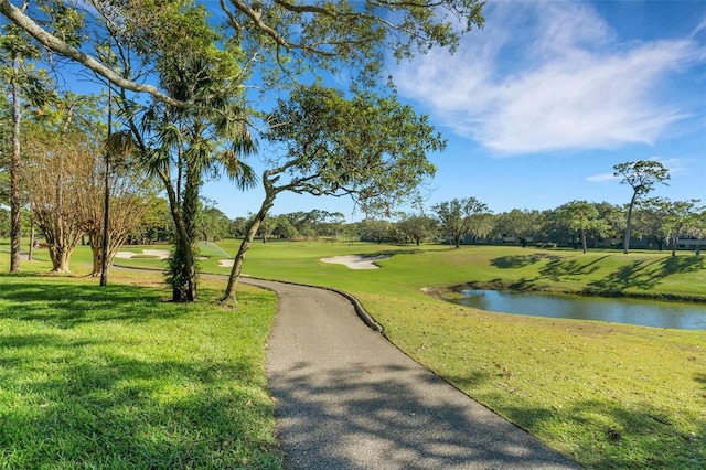 view of community with a yard and a water view