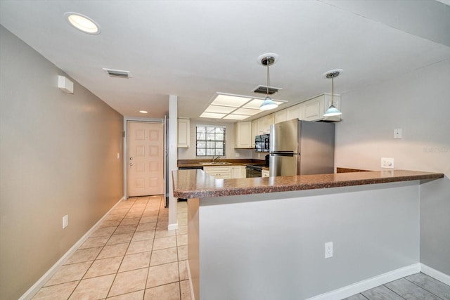 kitchen featuring black appliances, kitchen peninsula, sink, and hanging light fixtures