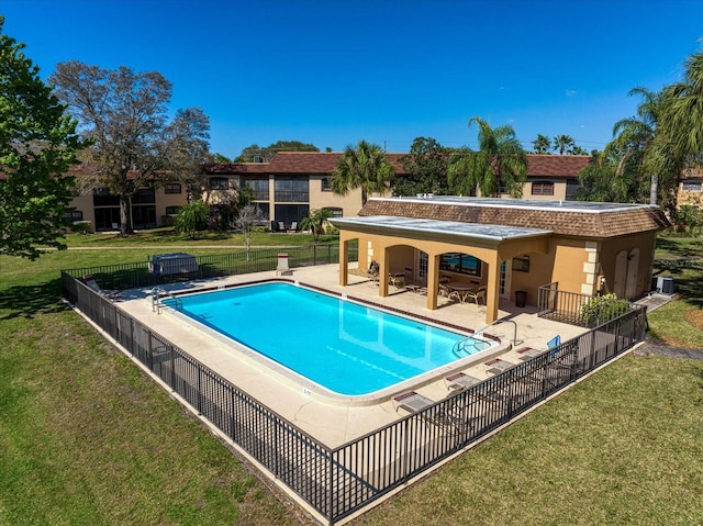 view of pool featuring a lawn, a patio area, and central AC