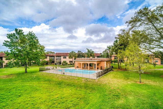 view of swimming pool featuring a lawn and a patio