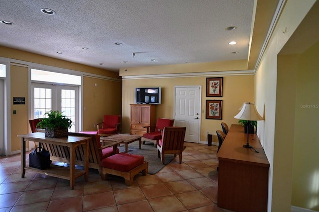 tiled living room with french doors and a textured ceiling