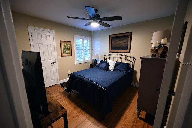 bedroom with ceiling fan and wood-type flooring