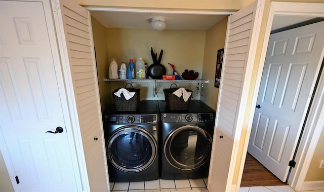 clothes washing area featuring washer and dryer and hardwood / wood-style flooring