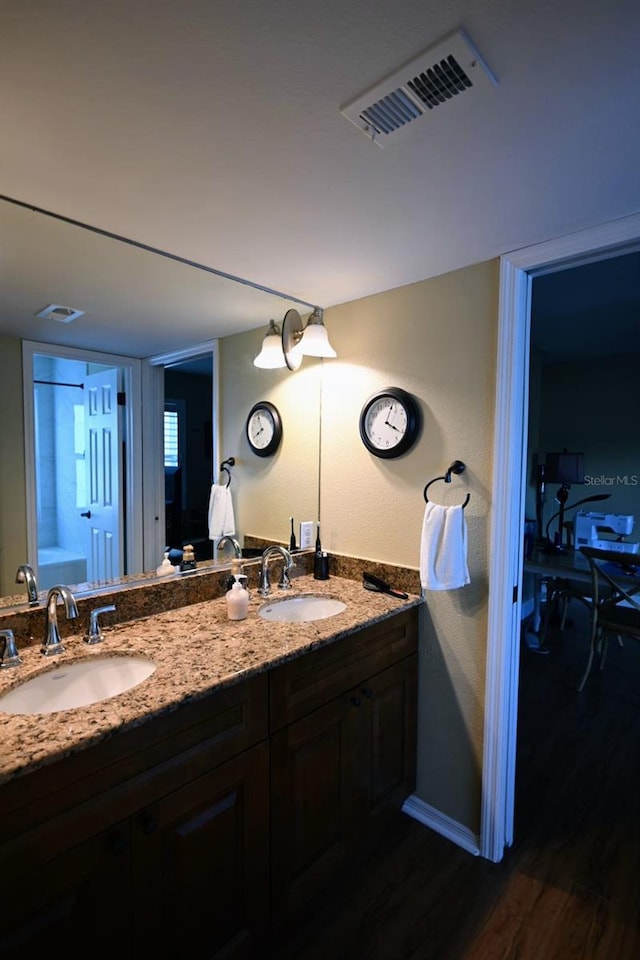 bathroom featuring hardwood / wood-style floors and vanity