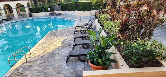 view of swimming pool featuring a patio area