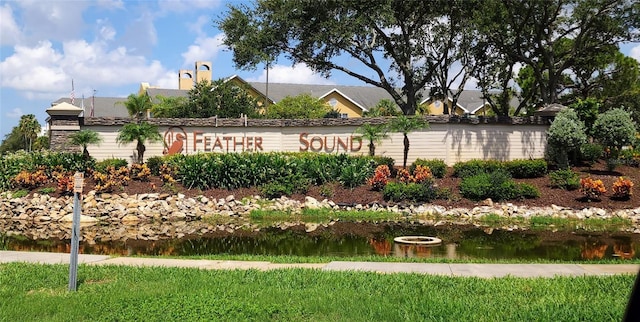 community / neighborhood sign with a water view