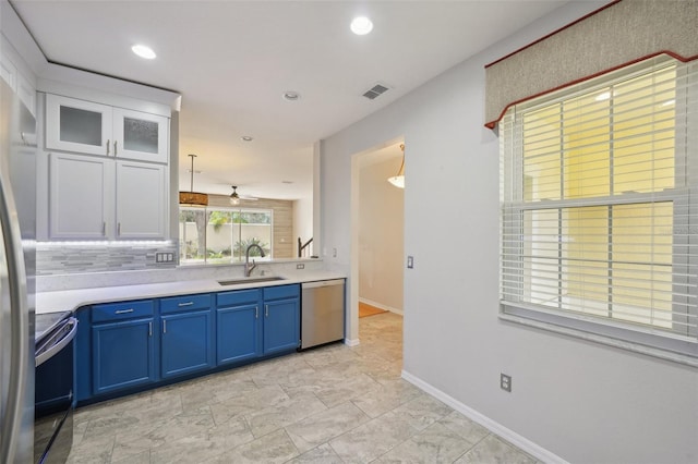 kitchen featuring white cabinetry, sink, appliances with stainless steel finishes, ceiling fan, and backsplash