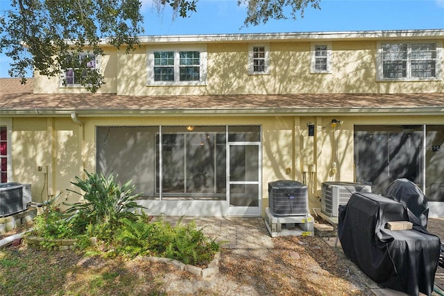 back of property with a patio and cooling unit