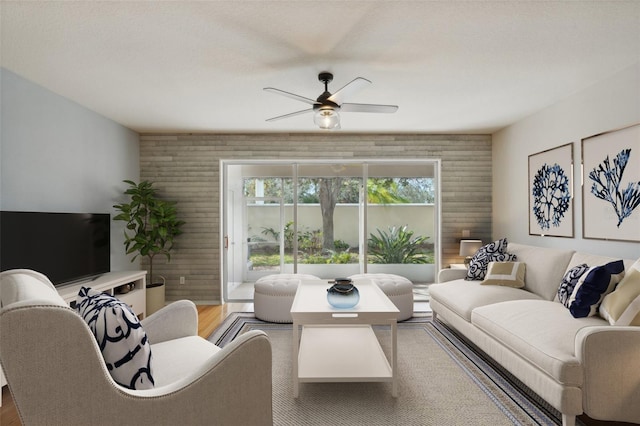 living room featuring hardwood / wood-style floors and ceiling fan