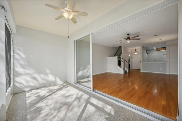 unfurnished sunroom featuring ceiling fan