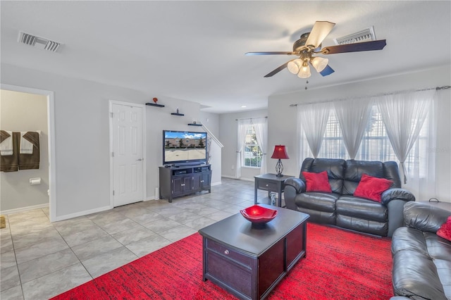 tiled living room featuring ceiling fan