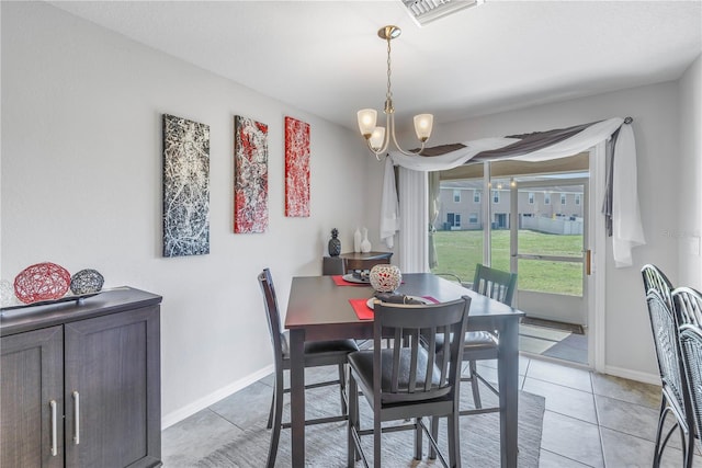 dining space with light tile patterned flooring and a notable chandelier