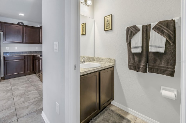 bathroom with tile patterned flooring and vanity