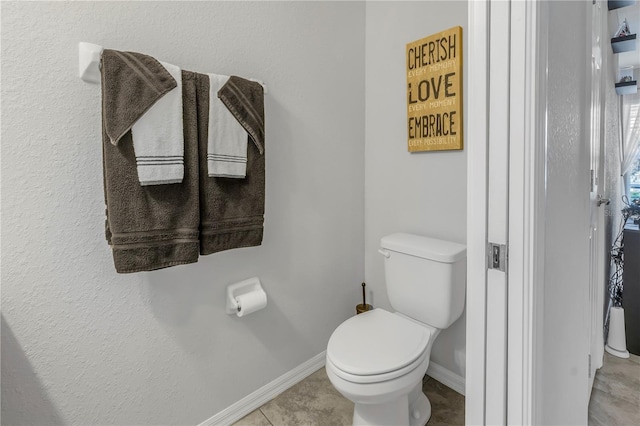 bathroom with tile patterned flooring and toilet