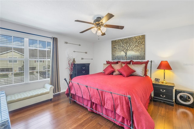 bedroom with ceiling fan and dark wood-type flooring