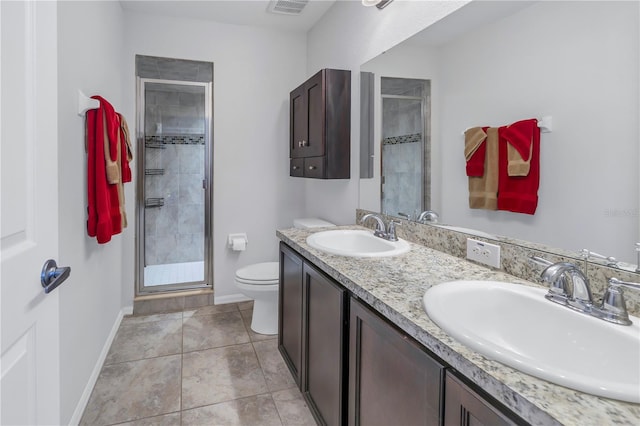 bathroom with tile patterned flooring, vanity, toilet, and an enclosed shower