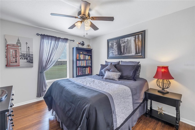 bedroom with ceiling fan and dark wood-type flooring