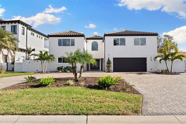 mediterranean / spanish home featuring a garage