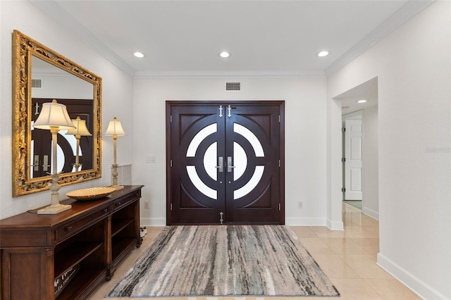 foyer featuring light tile patterned flooring and ornamental molding